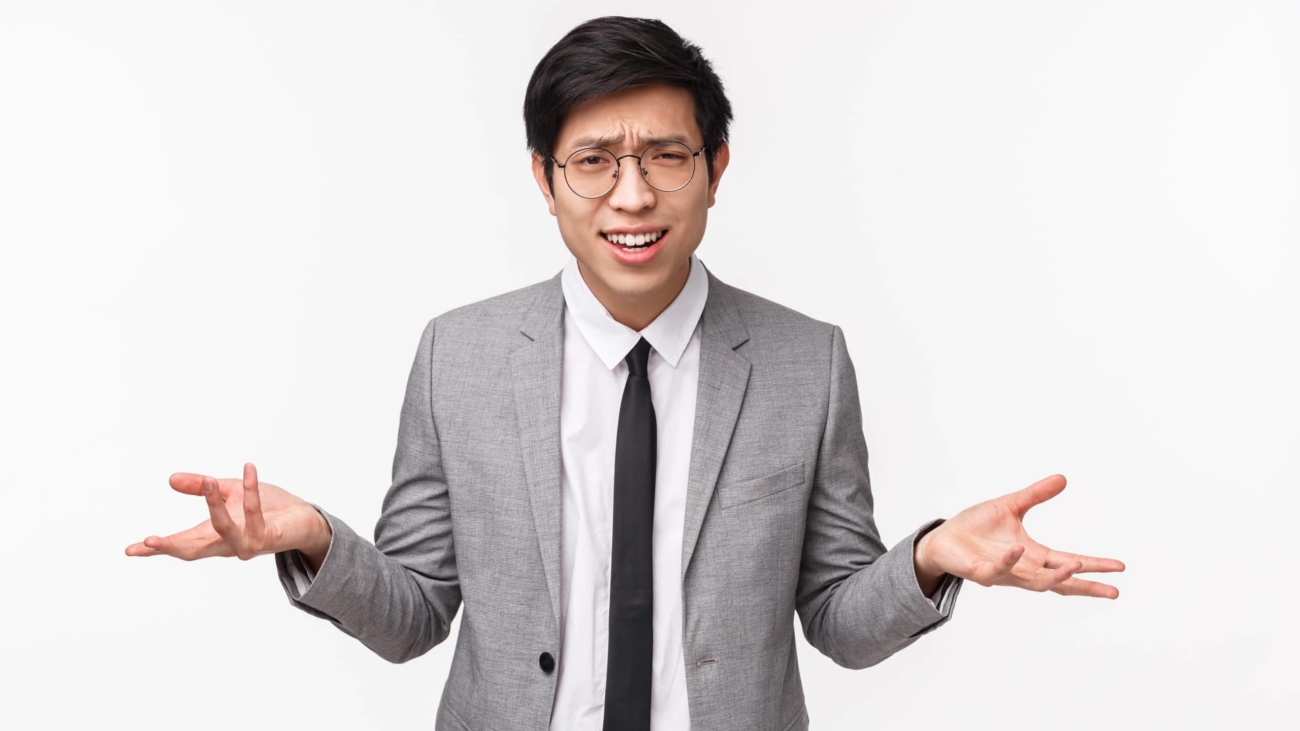 Why what do you want. Waist-up portrait of bothered and frustrated young asian man in grey suit being disappointed and upset with someone saying nonsense, strange accusations.